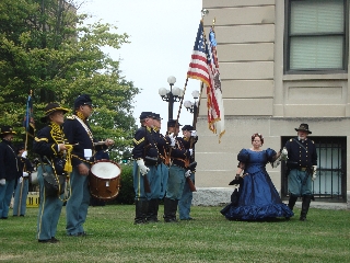The Colonel escorts Mrs. Lincoln for the flag raising ceremony 